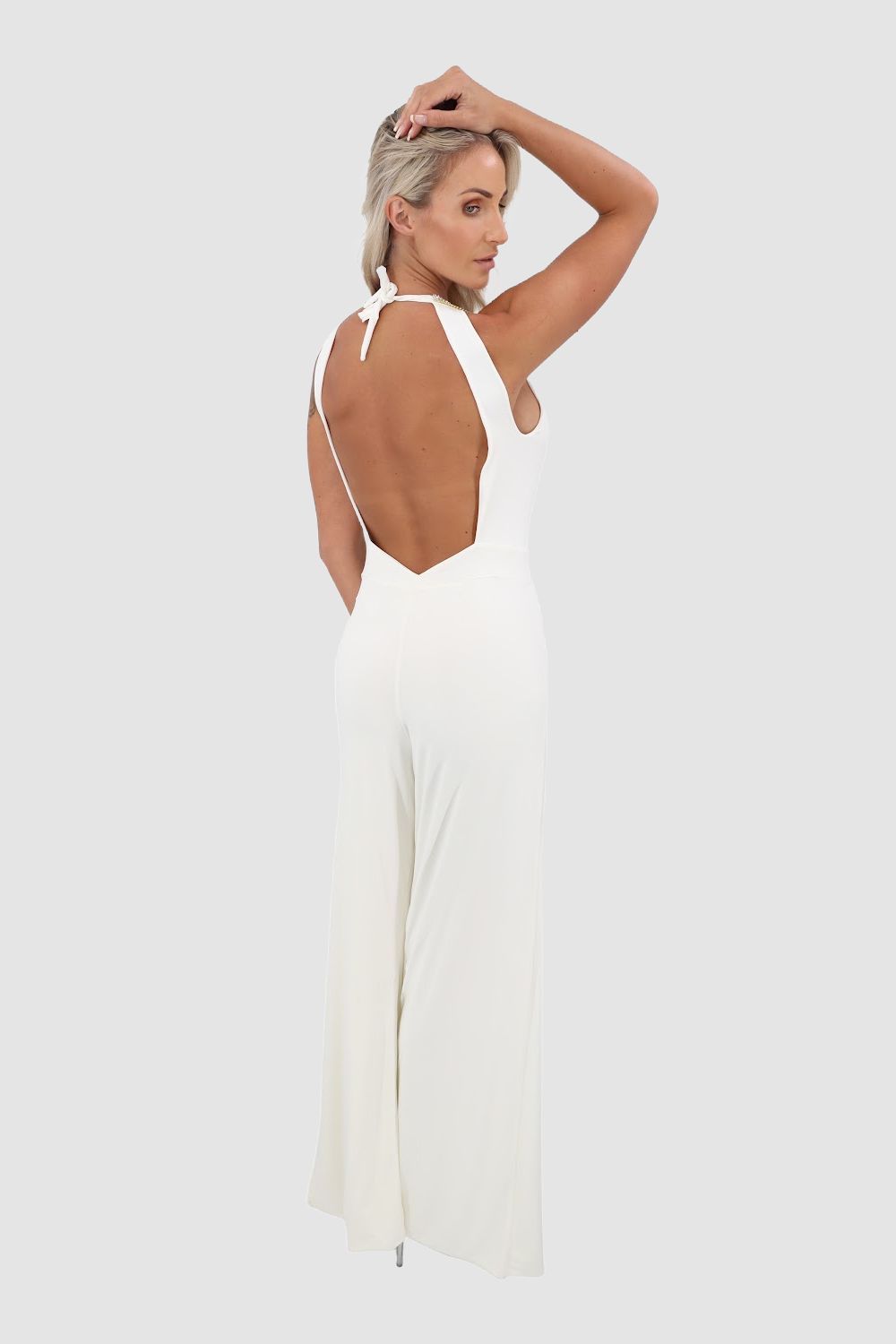 Vie Sauvage White jumpsuit with silver crystal trim and open legs. Fabric has a lot of stretch and adapts to your body. Open back.