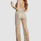 Jovani nude jumpsuit with all over crystal flowers. Open back and slit on one whole leg.